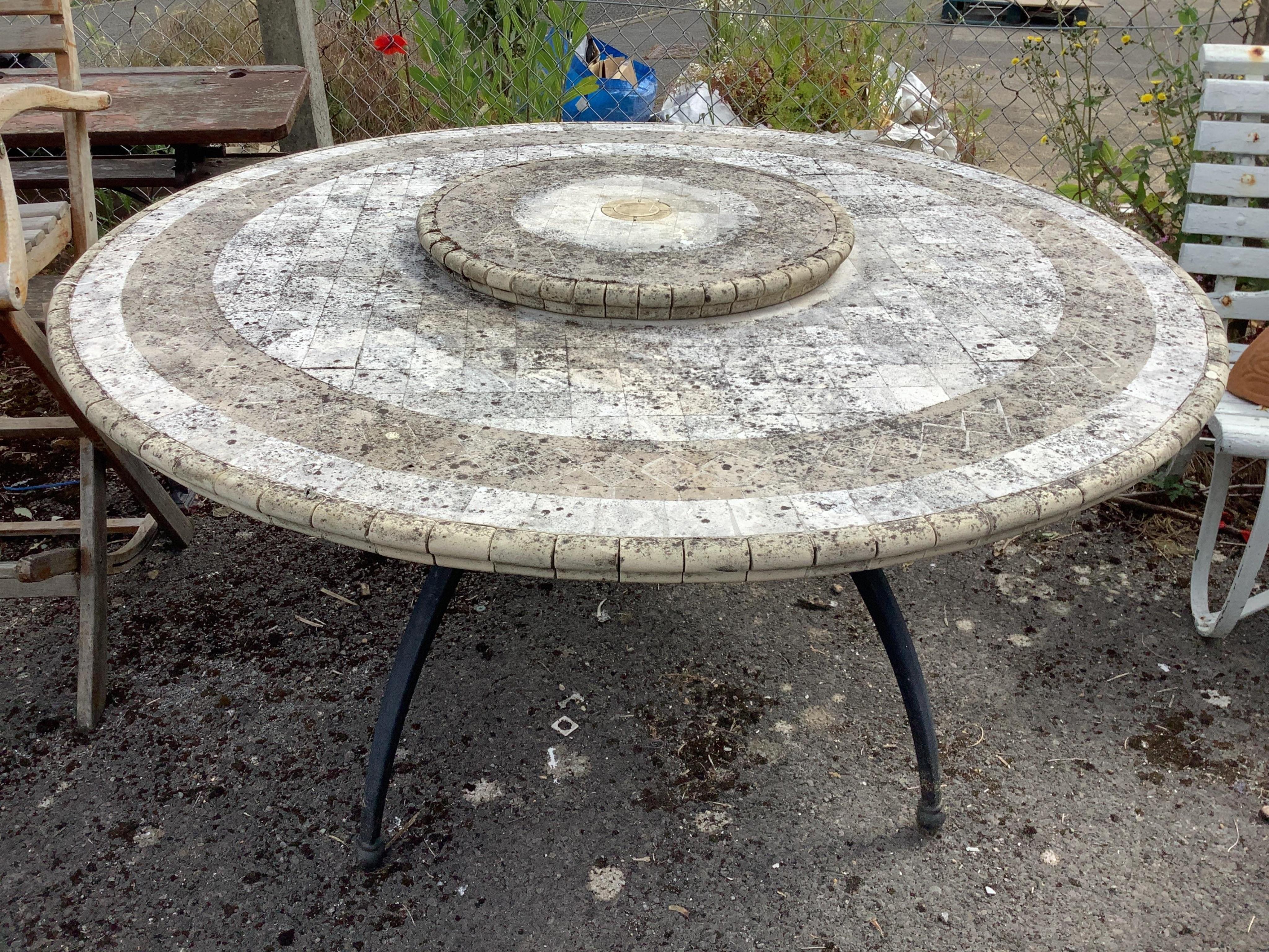 A circular mosaic stone garden table with 'Lazy Susan', diameter 150cm, height 74cm. Condition - fair